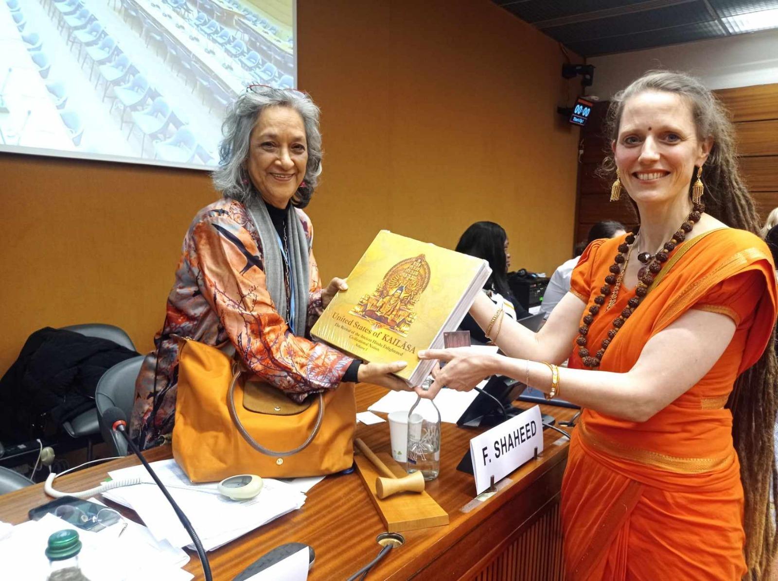 A KAILASA representative presents the KAILASA book to the UN Special Rapporteur on the Right to Education